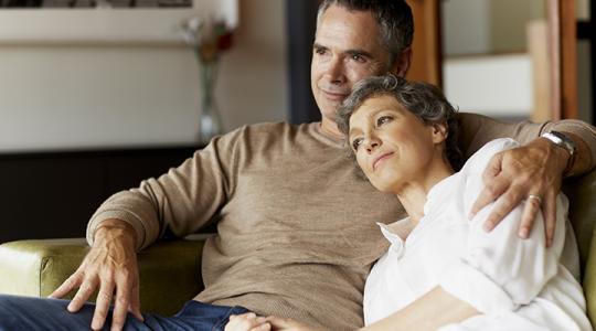 Older white couple relaxing on the couch