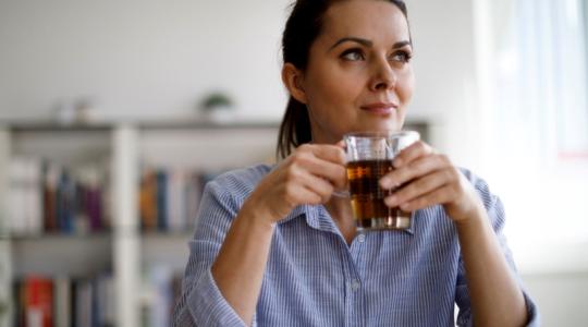 Woman drinking tea in her home